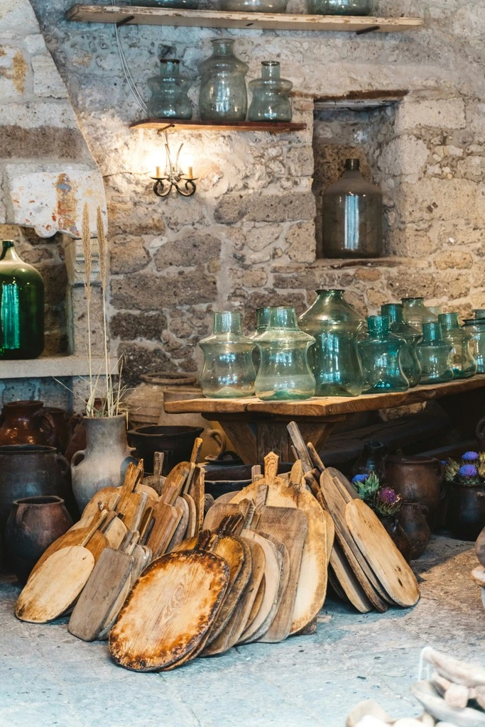 A table topped with lots of wooden utensils in a rustic market