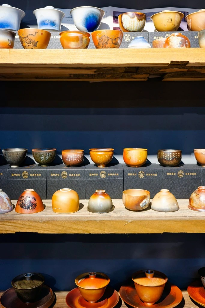 A shelf filled with handmade ceramics